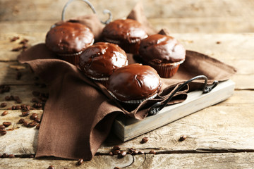 Tasty homemade chocolate muffins on wooden table