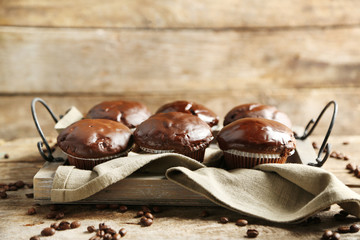 Tasty homemade chocolate muffins on wooden table