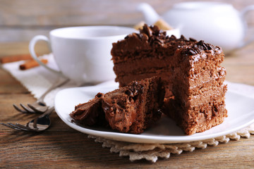 Slices of tasty chocolate cake on plate on table close up