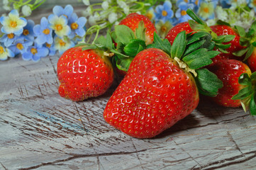 Fresh strawberries on old wooden board