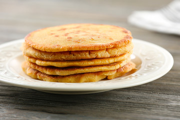 Tasty fritters on plate on table close up
