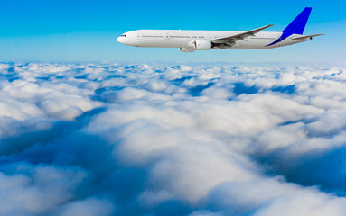 Fototapeta na wymiar Passenger airplane flying above dramatic clouds