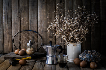 Egg, old coffee, dry little flowers, old badminton racket, bottl
