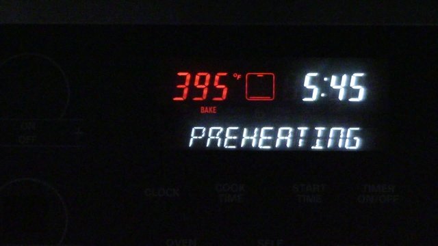 An oven preheating & showing clock display