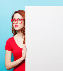 girl in red dress and glasses with white board