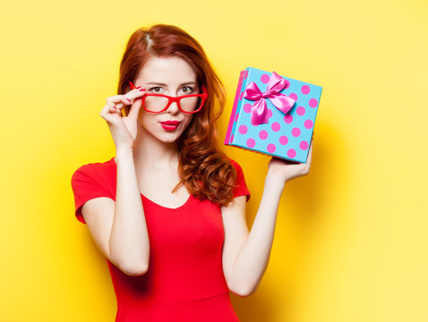  girl in red dress with glasses and gift box