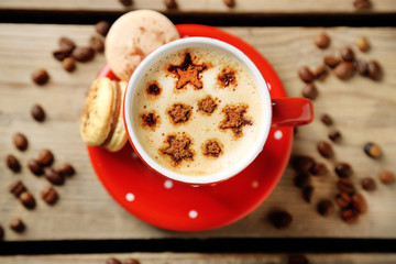 Cup of coffee  and macaroons on old wooden table