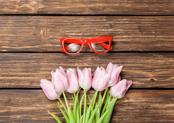 Red glasses and bouquet of tulips