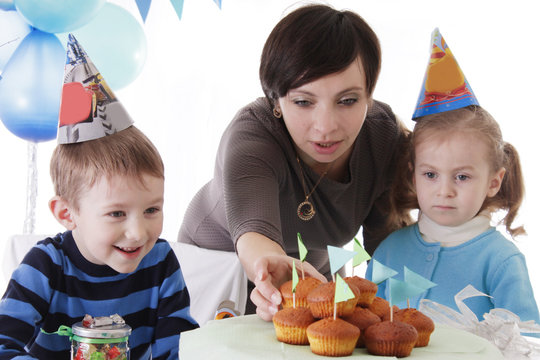 Mother And Two Baby Having Birthday Party In Blue Decor