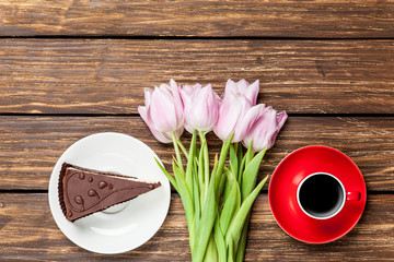 Cake and cup of coffee with tulips