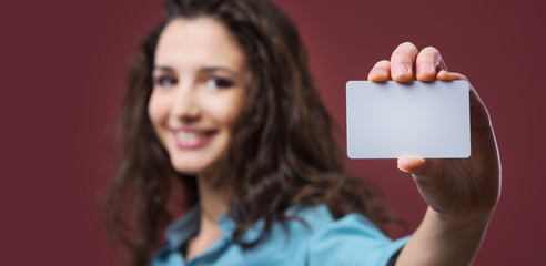 Young woman holding a business card