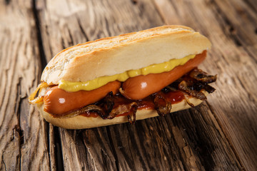 Hot dog on wooden table.
