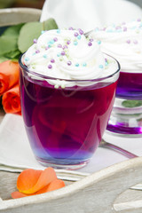 Colorful jelly with whipped cream and candy topping