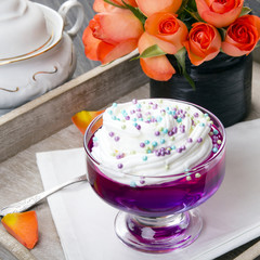 Colorful jelly with whipped cream and candy topping