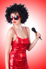 Pop star with mic in red dress on white