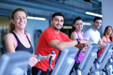 Group of people running on treadmills
