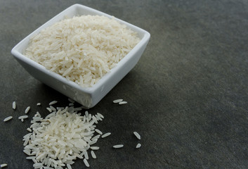 White Rice Spills Onto Black Cutting Board