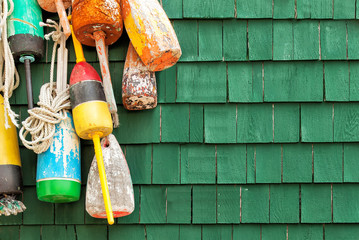 Lobster buoys hanging on a green shingled wall - 79531798