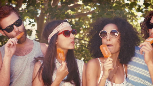 In high quality format hipster friends enjoying ice lollies