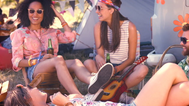 In high quality format hipsters having fun in their campsite