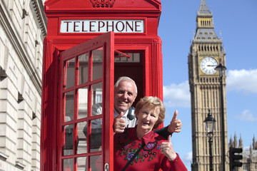 Senior couple with red telephone box in London
