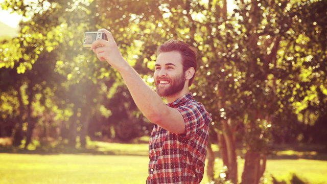 In high quality 4k format handsome hipster taking a selfie
