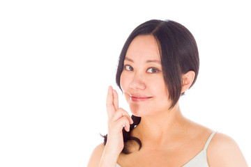 Pregnant asian woman isolated on white fingers crossed for luck