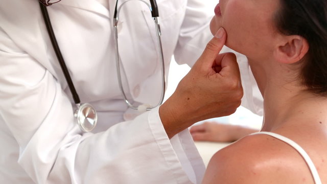 Dermatologist examining a patients face