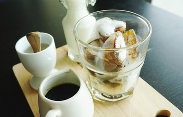 Ice latte coffee serving on timber block