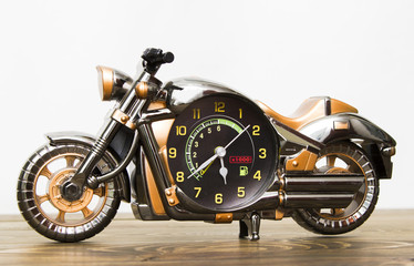 Fototapeta na wymiar watch toy in the form of a motorcycle