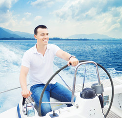 A handsome man sailing in the sea