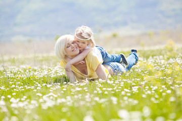 Fototapeta premium Happy woman with a child resting on the nature