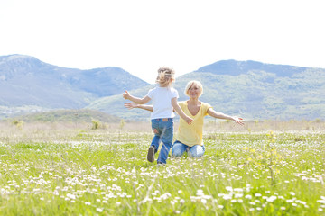 Fototapeta premium Happy woman with a child resting on the nature
