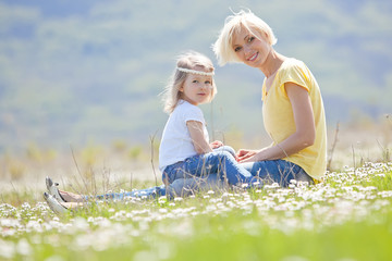 Fototapeta premium Happy woman with a child resting on the nature