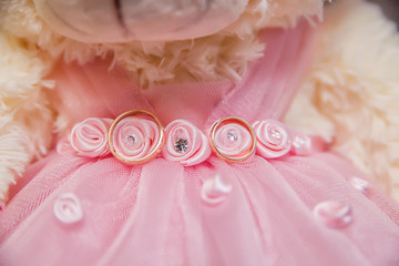 wedding rings on pink lace