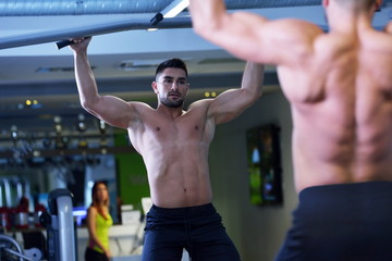Fototapeta na wymiar handsome man exercising at the gym