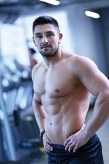 Fototapeta premium handsome man exercising at the gym