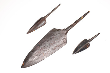 Three ancient arrowheads on a white background