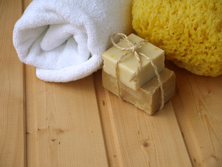 Obraz na płótnie Canvas Towel,soap and sponge on the wooden background