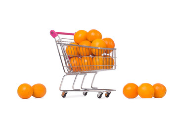 Supermarket trolley full of oranges isolated on white