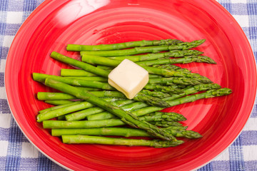 Green Asparagus on Red Plate with Butter