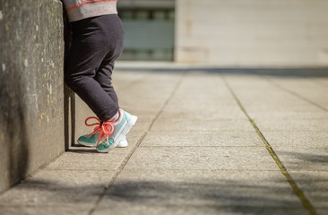 Little girl with sneakers and leggins training outdoors