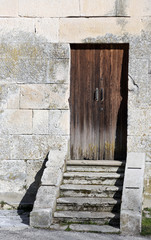 ancient wooden door to enter in the belltower