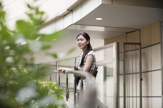 A woman on a walkway in Namba Park office and shopping complex. 