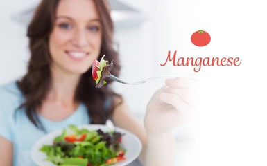 Manganese against brunette offering healthy salad