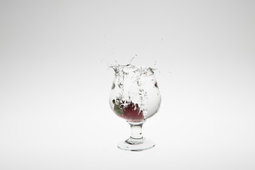 Close-up image of strawberry dropped to water