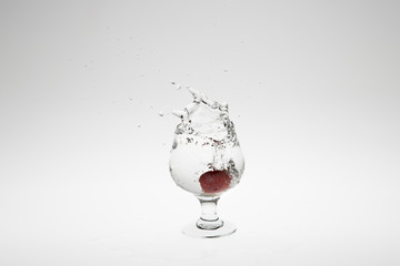 Close-up image of strawberry dropped to water