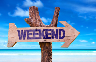 Weekend wooden sign with beach background