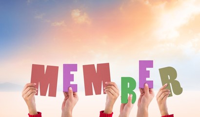 Composite image of hands holding up member