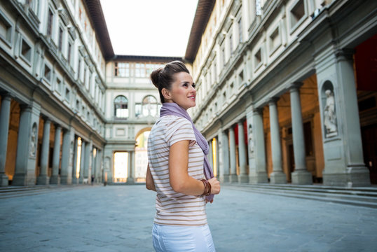 Young woman standing near uffizi gallery in florence, italy